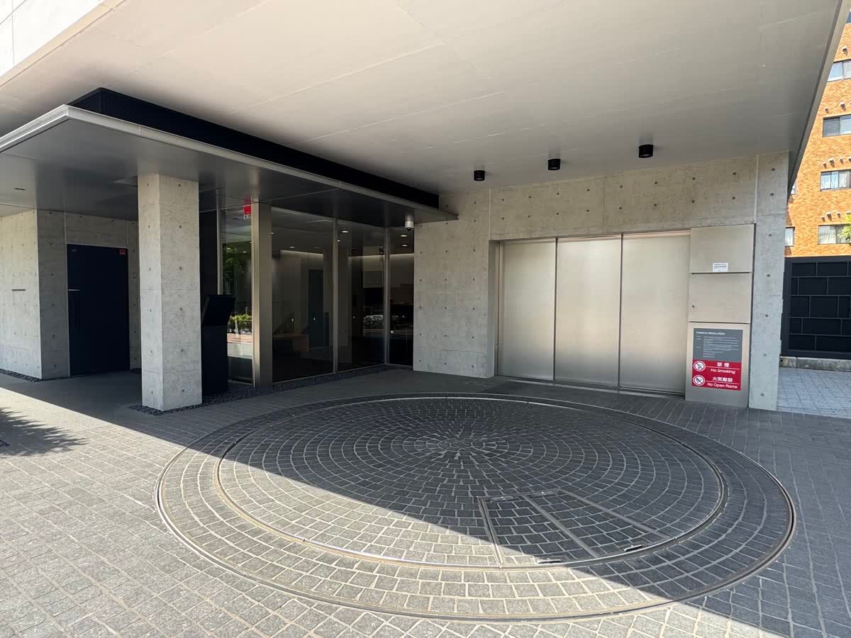 The entrance passage at dusk, concrete washed in warm light.
